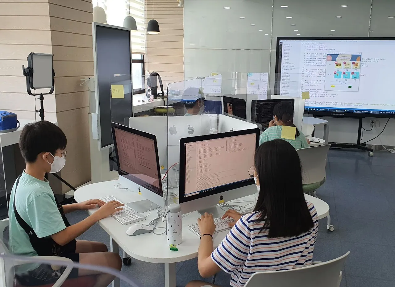 Gifted Education Center instructor teaching text-based coding with Python and JavaScript to advanced students